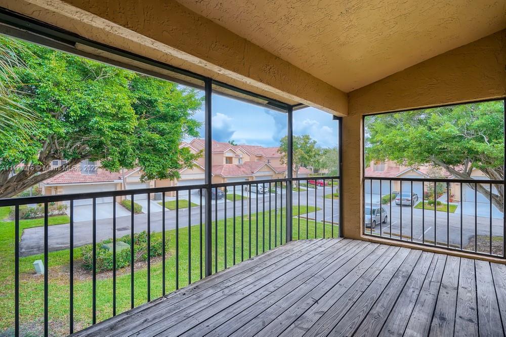 23060 Aqua, Unit 8 Boca Raton, FL 33433 - Photo 29 of 33 a view of a balcony with wooden floor