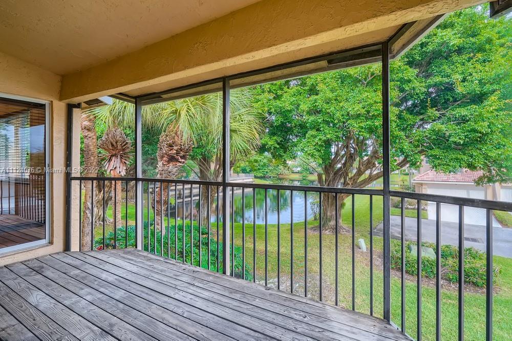 23060 Aqua, Unit 8 Boca Raton, FL 33433 - Photo 31 of 33 a view of balcony with wooden floor