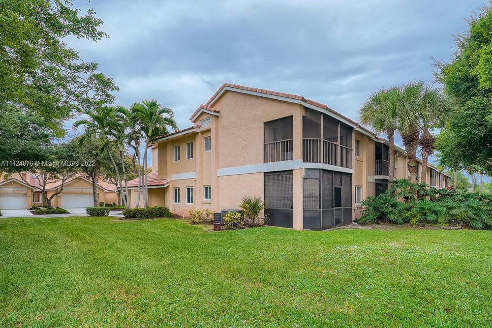 23060 Aqua, Unit 8 Boca Raton, FL 33433 - Photo 32 of 33 a big house with a big yard and more windows