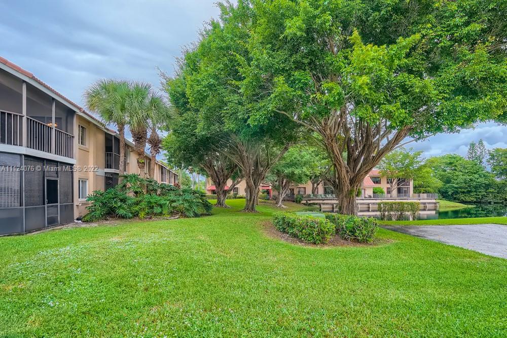 23060 Aqua, Unit 8 Boca Raton, FL 33433 - Photo 33 of 33 a front view of a house with garden