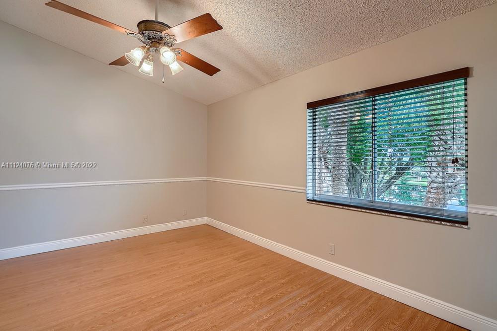 23060 Aqua, Unit 8 Boca Raton, FL 33433 - Photo 5 of 33 an empty room with a window and a fan