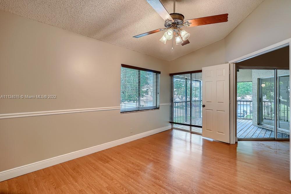 23060 Aqua, Unit 8 Boca Raton, FL 33433 - Photo 7 of 33 a view of an empty room with window and wooden floor