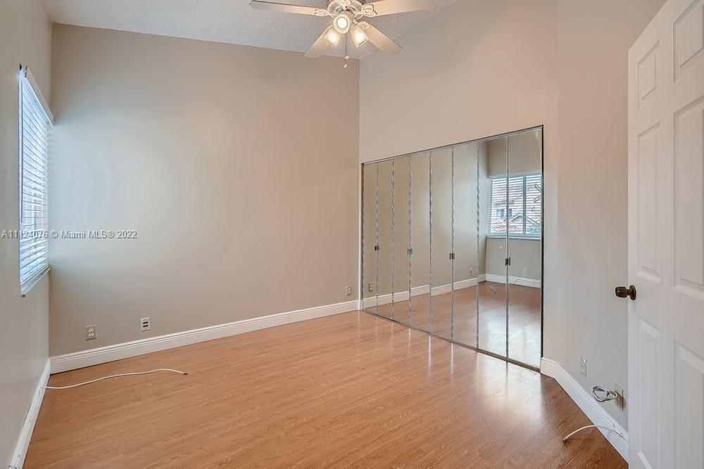 23060 Aqua, Unit 8 Boca Raton, FL 33433 - Photo 9 of 33 a view of an empty room with wooden floor