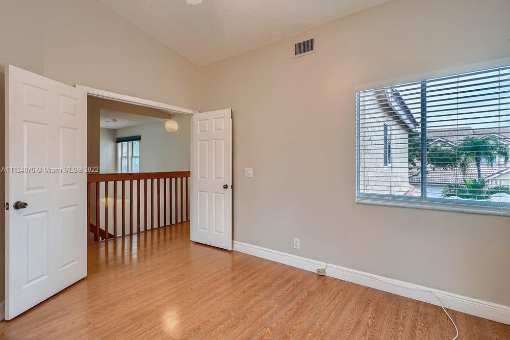 23060 Aqua, Unit 8 Boca Raton, FL 33433 - Photo 10 of 33 a view of a room with wooden floor and a window