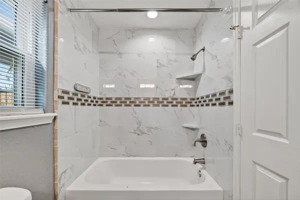 a bathroom with a bathtub and a shower