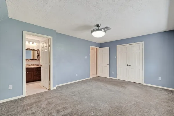 a view of an empty room with a bathroom