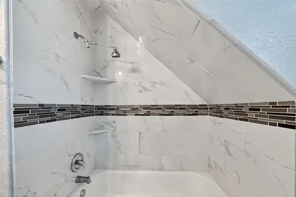 a bathroom with a bathtub and a shower