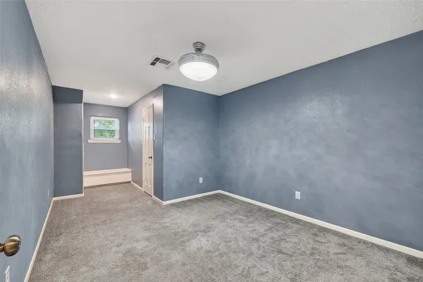 an empty room with windows and closet