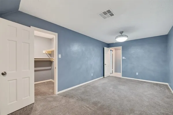 a view of an empty room and closet area
