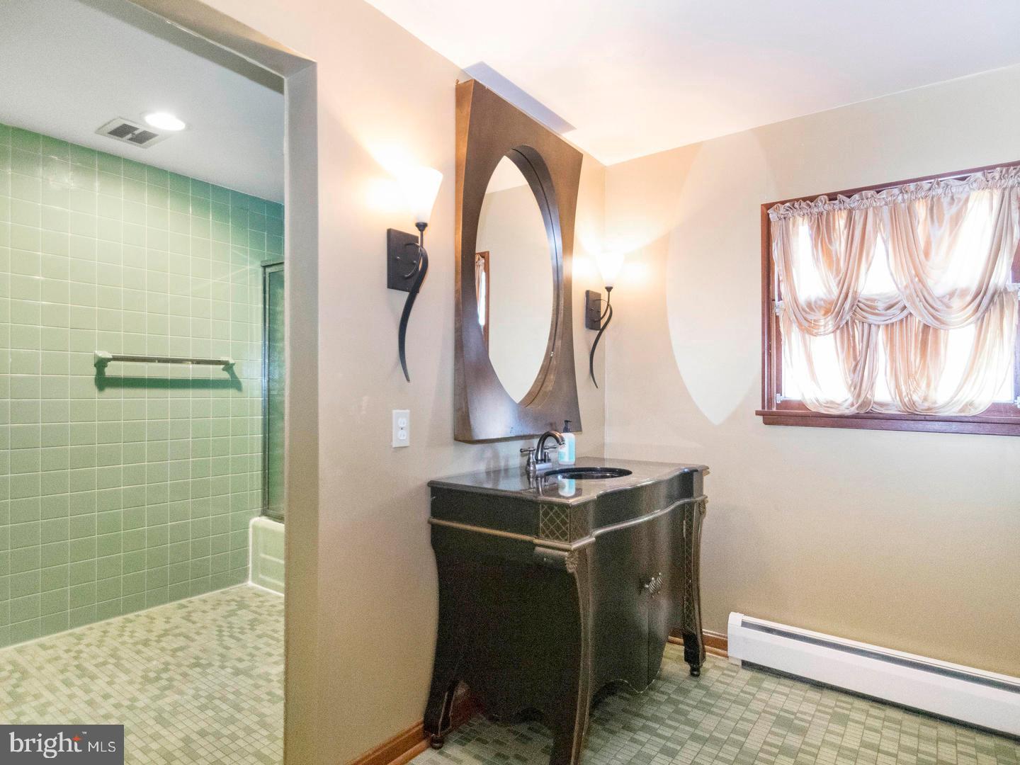 104 Powell Road Springfield, PA 19064 - Photo 17 of 30 a view of a bathroom with a sink and mirror