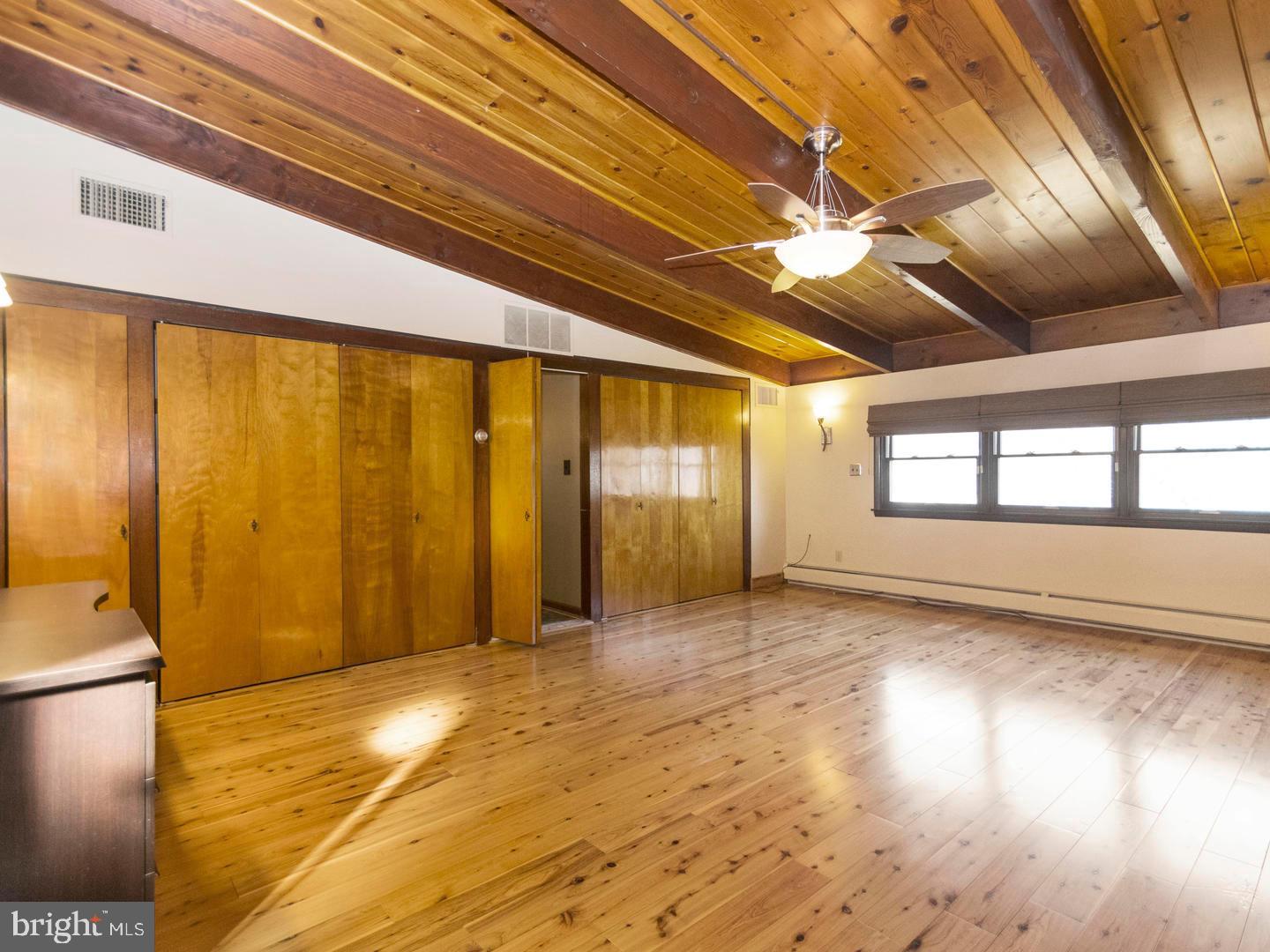 104 Powell Road Springfield, PA 19064 - Photo 20 of 30 a view of empty room with wooden floor and fan