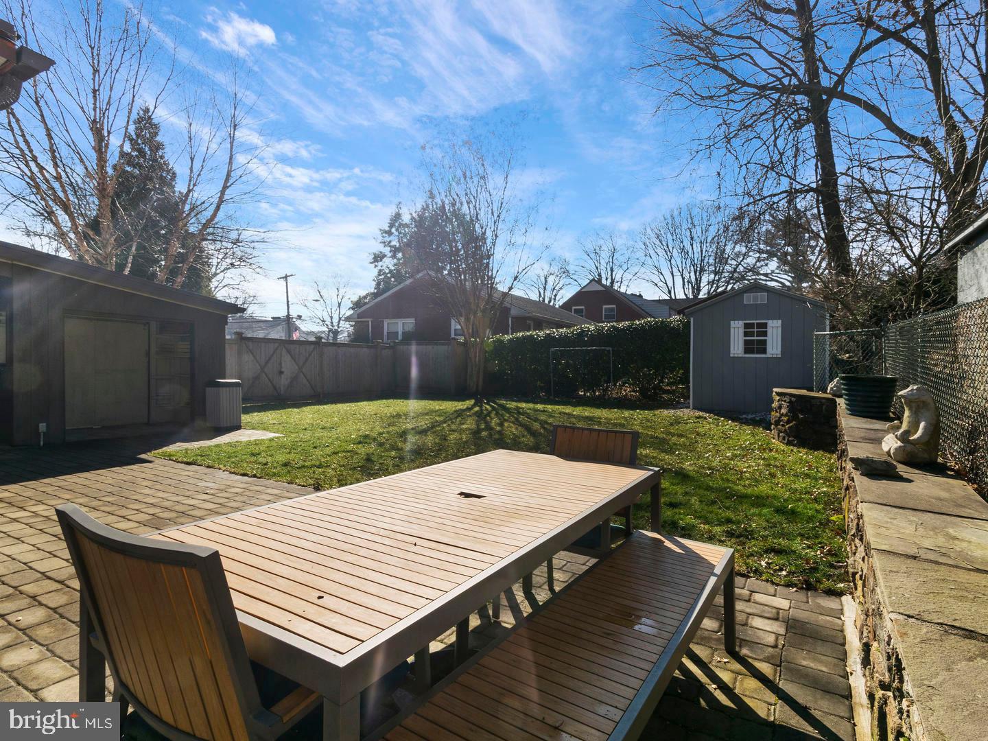 104 Powell Road Springfield, PA 19064 - Photo 26 of 30 a view of a patio with table and chairs with wooden floor and fence