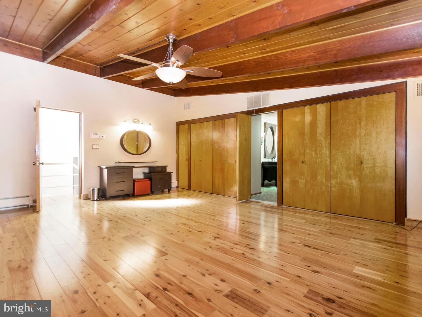 104 Powell Road Springfield, PA 19064 - Photo 5 of 30 a view of an empty room with wooden floor and a window