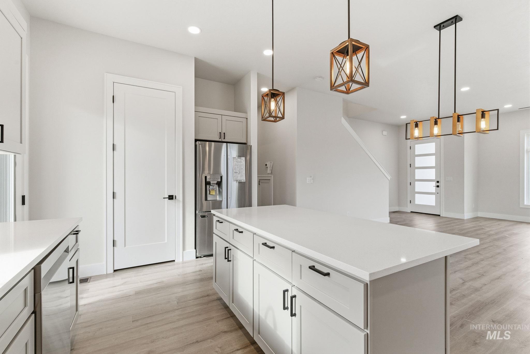 6821 West Ustick Road Boise, ID 83704 - Photo 42 of 42 Kitchen with pendant lighting, a kitchen island, stainless steel appliances, and open floor plan