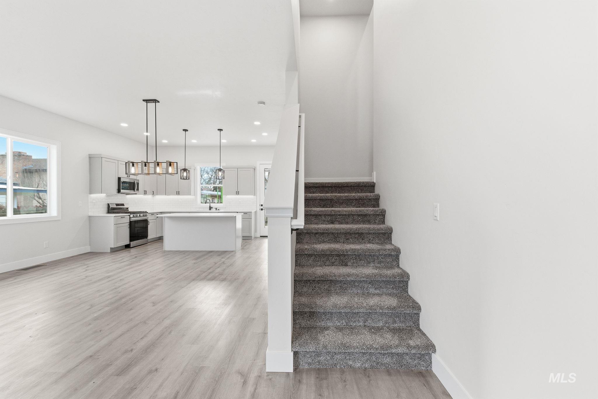 6821 West Ustick Road Boise, ID 83704 - Photo 20 of 42 Stairway featuring wood finished floors and recessed lighting