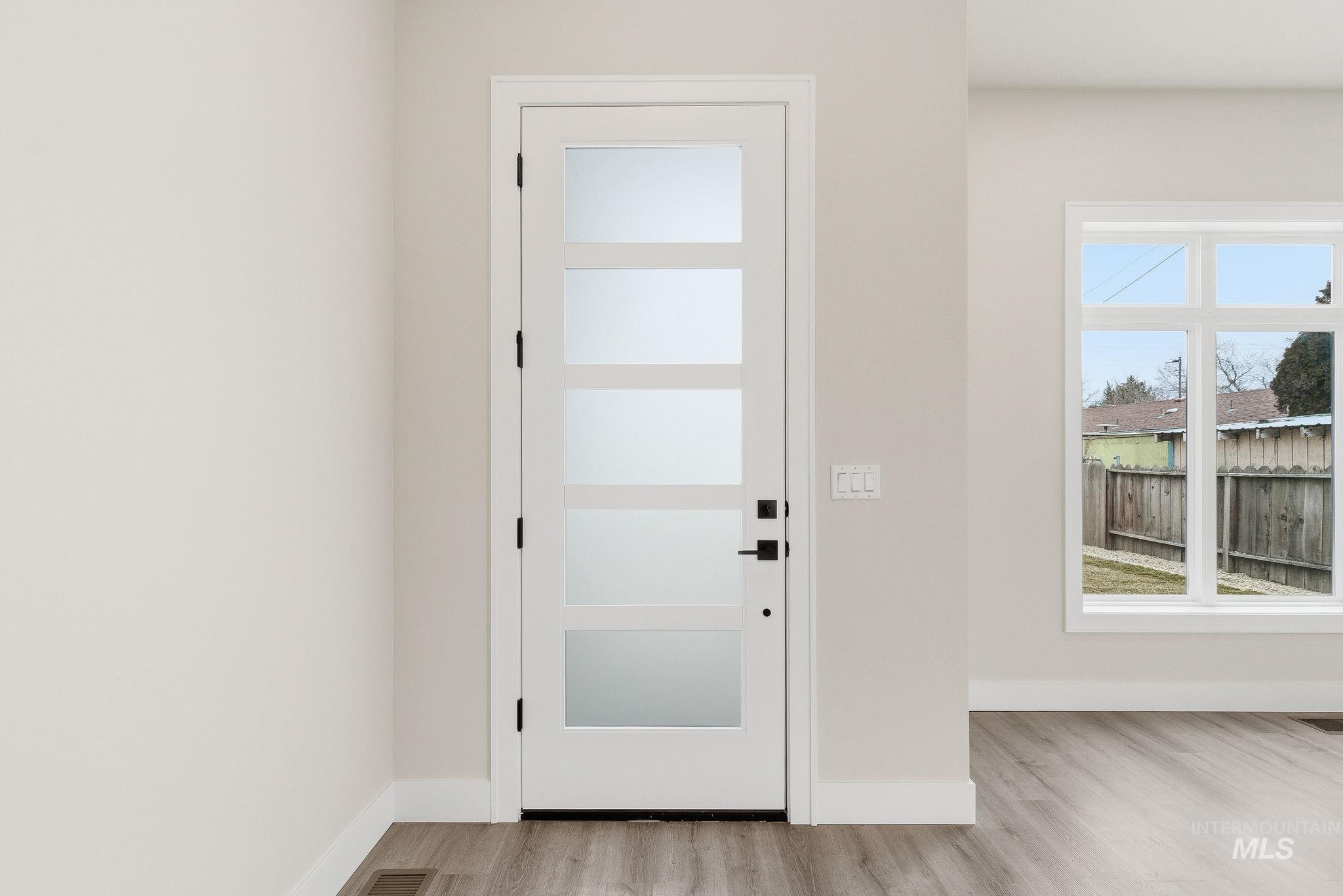 6821 West Ustick Road Boise, ID 83704 - Photo 3 of 42 Entryway featuring light wood-type flooring and baseboards