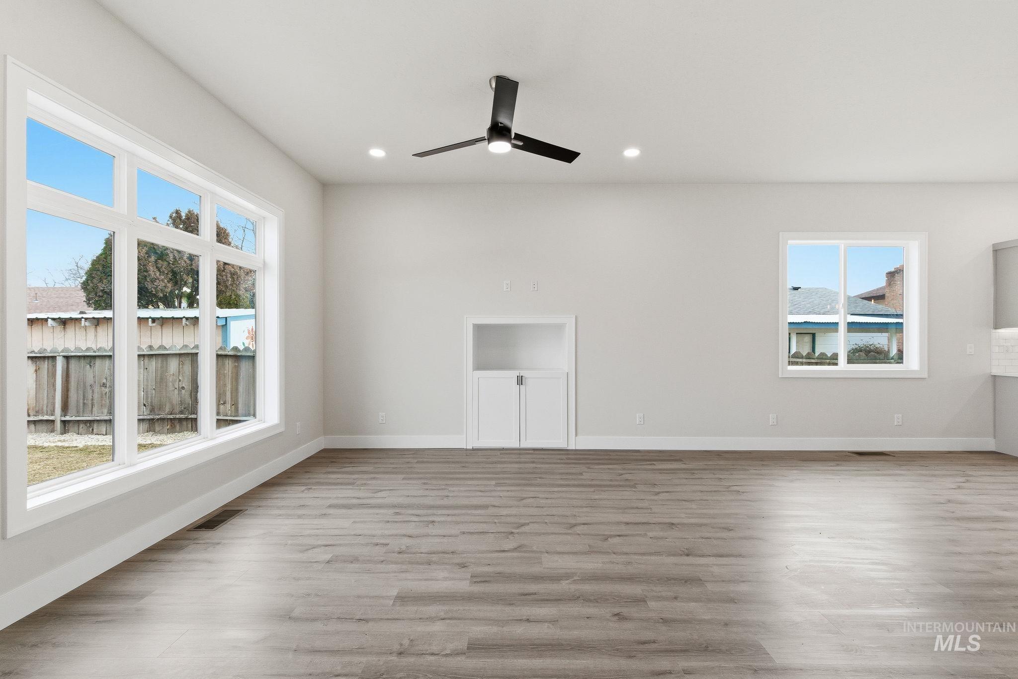 6821 West Ustick Road Boise, ID 83704 - Photo 6 of 42 Unfurnished room featuring light wood-style floors, a ceiling fan, and recessed lighting
