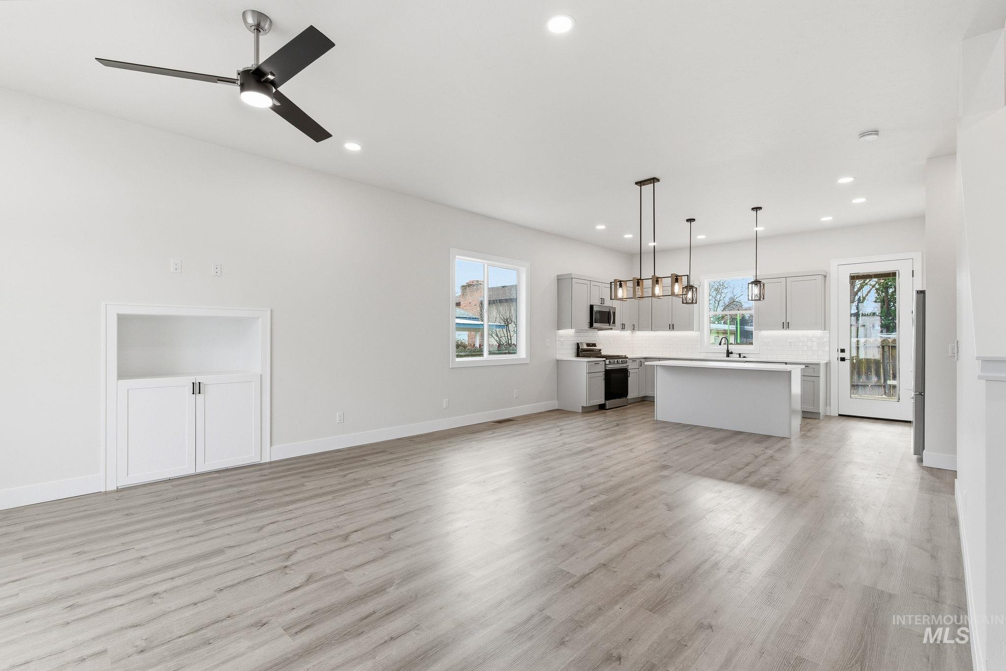 6821 West Ustick Road Boise, ID 83704 - Photo 7 of 42 Unfurnished living room featuring light wood finished floors, recessed lighting, and ceiling fan