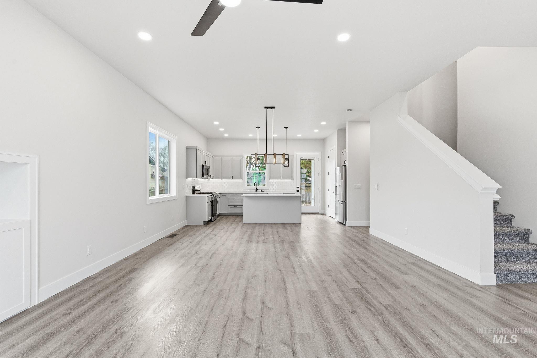 6821 West Ustick Road Boise, ID 83704 - Photo 8 of 42 Unfurnished living room with recessed lighting, light wood-style floors, and ceiling fan