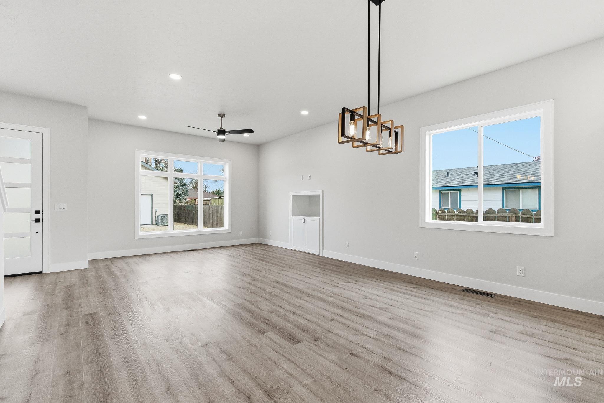6821 West Ustick Road Boise, ID 83704 - Photo 9 of 42 Unfurnished living room with a ceiling fan, light wood-style floors, and recessed lighting