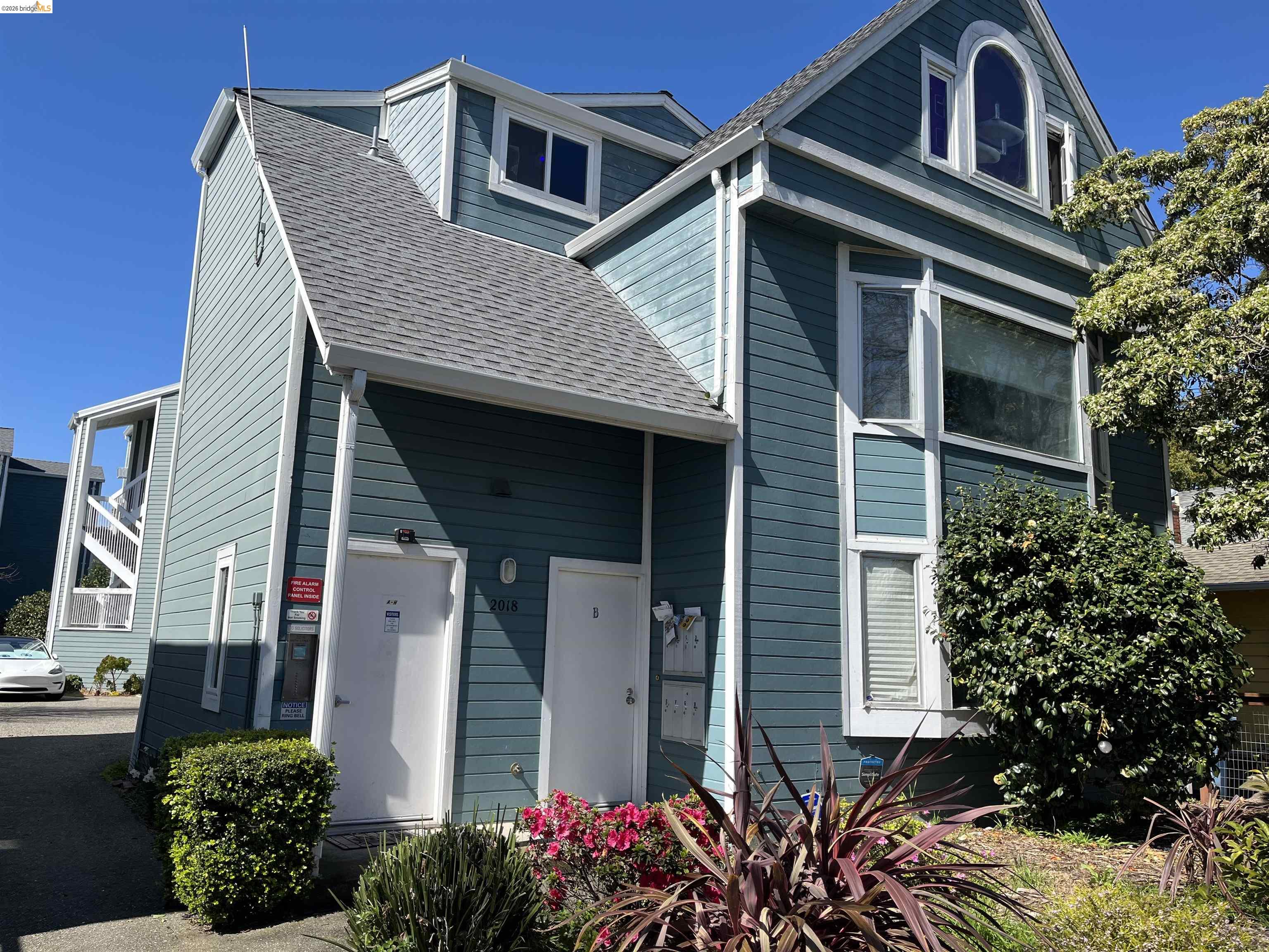 2018 Ninth Street, Unit B Berkeley, CA 94710 - Photo 1 of 5 a front view of a house with plants