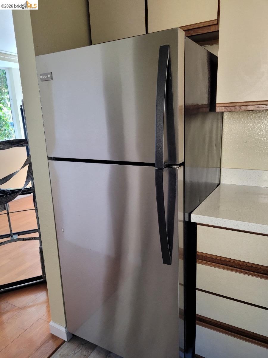 2018 Ninth Street, Unit B Berkeley, CA 94710 - Photo 3 of 5 a white refrigerator freezer and a stove sitting inside of a kitchen