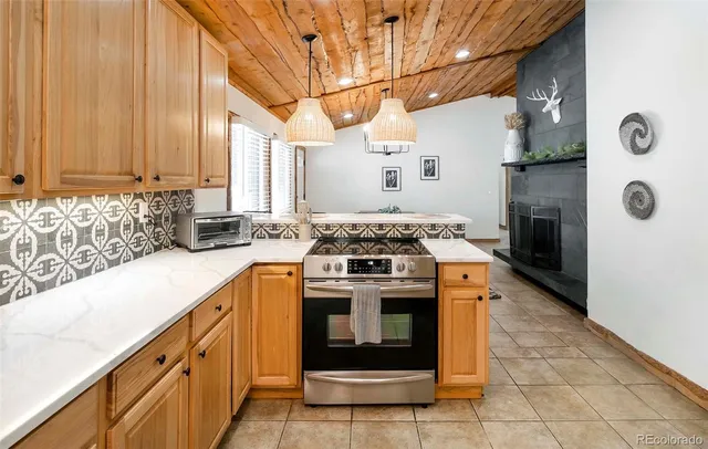 a kitchen with stainless steel appliances granite countertop a stove a sink and a refrigerator