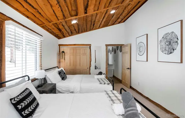 a bedroom with a large bed and a window