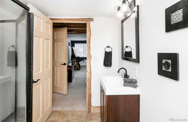 a en suite bathroom with a sink and mirror