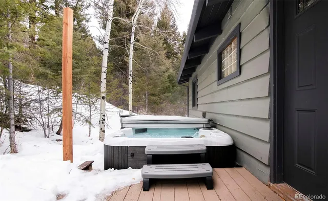 a view of balcony with two chairs and a wooden fence