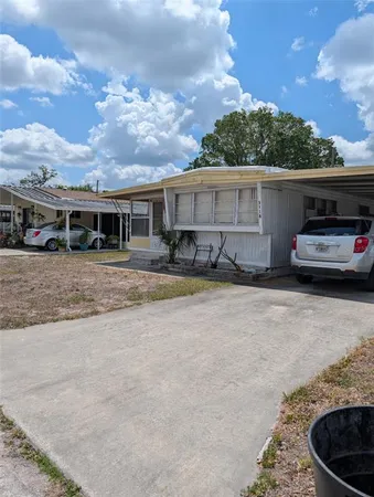 a view of a car park in front of house