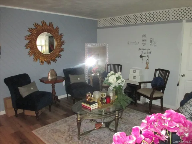 a living room with furniture and a mirror