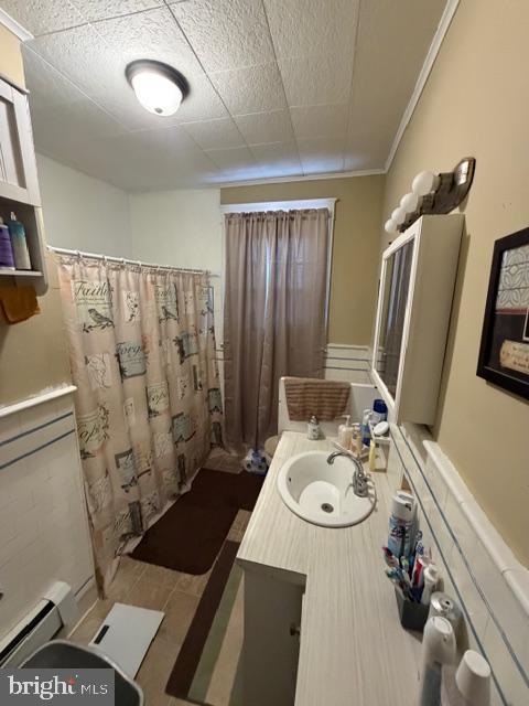 1319 Perry Street Reading, PA 19604 - Photo 11 of 16 a bathroom with a sink a toilet and shower curtain