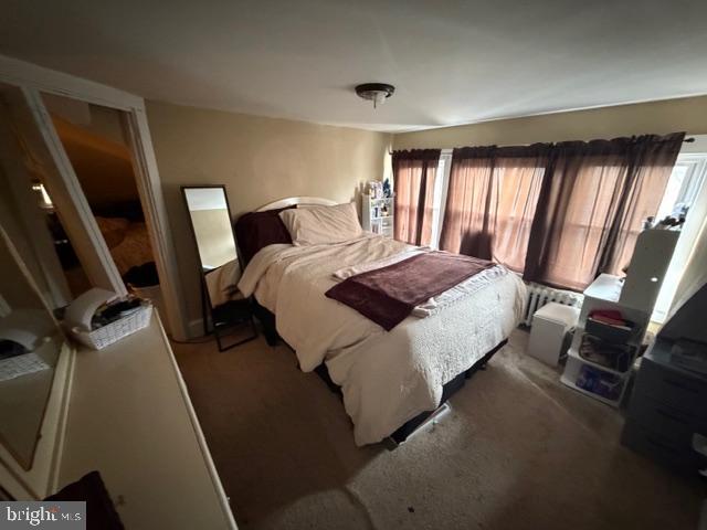 1319 Perry Street Reading, PA 19604 - Photo 13 of 16 a bedroom with a bed a mirror and a window
