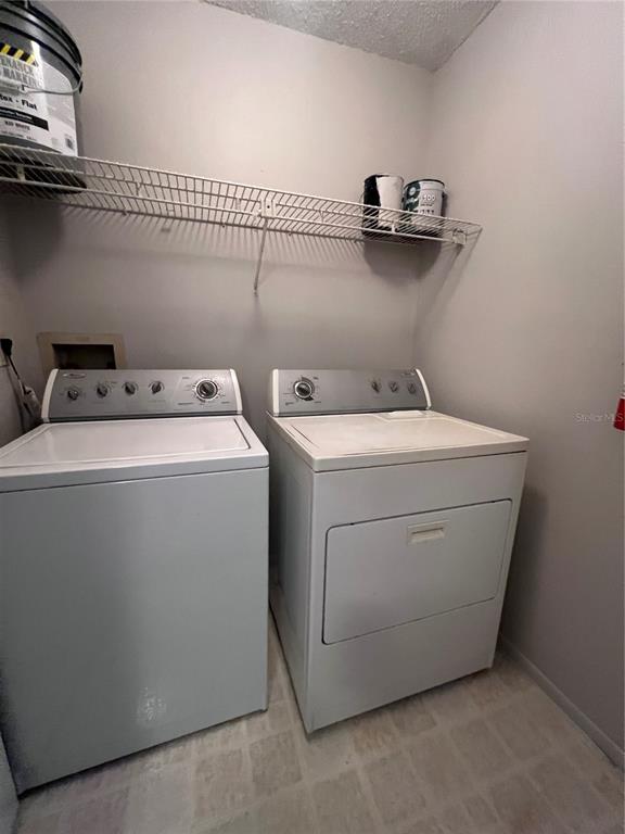 643 Dory Lane, Unit 202 Altamonte Springs, FL 32714 - Photo 11 of 14 a utility room with dryer and washer