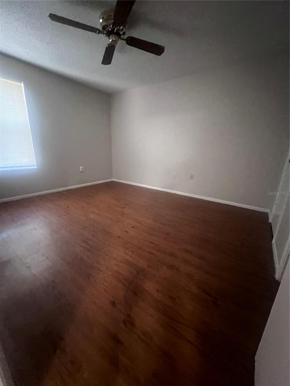 643 Dory Lane, Unit 202 Altamonte Springs, FL 32714 - Photo 4 of 14 an empty room with wooden floor and windows