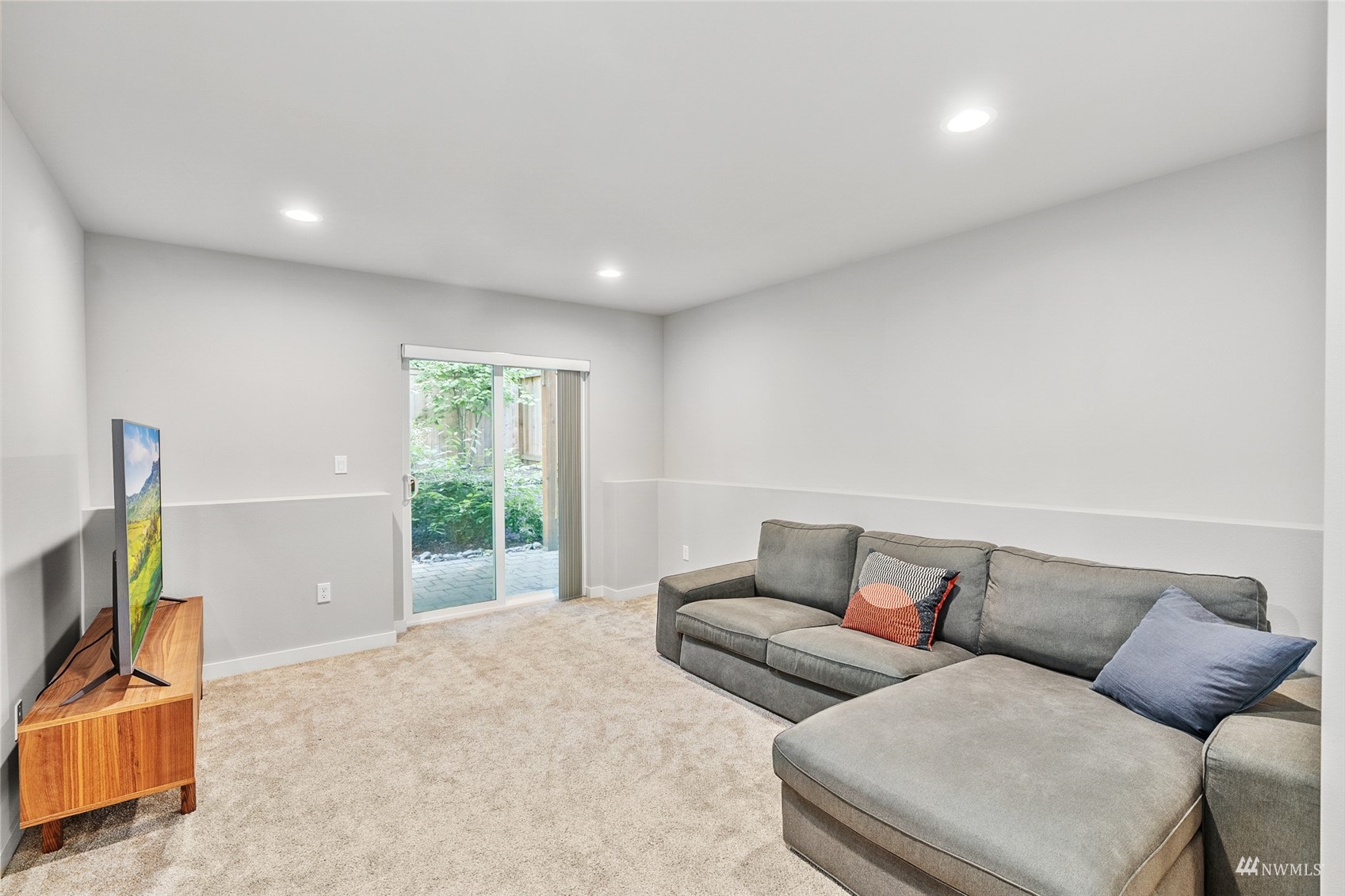 22811 23rd Avenue Southeast, Unit 11 Bothell, WA 98021 - Photo 24 of 30 a living room with furniture and a flat screen tv