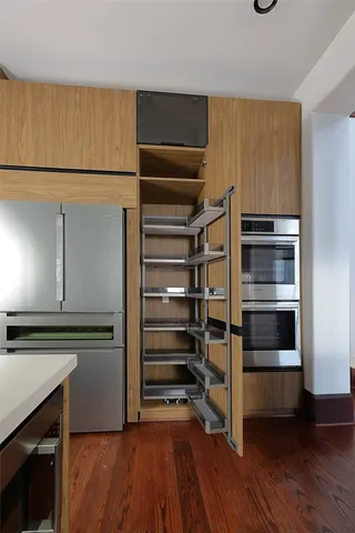 a view of walk in closet with empty racks