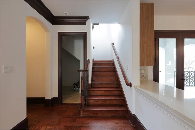a view of a hallway with wooden floor and entryway