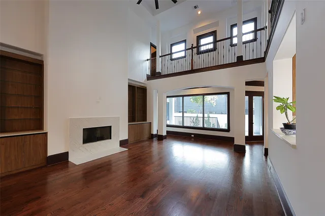 a view of front door with hallway and wooden floor