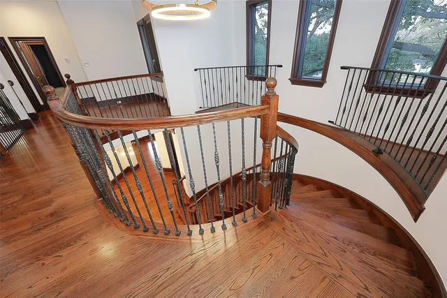 a view of staircase with railing and a rug