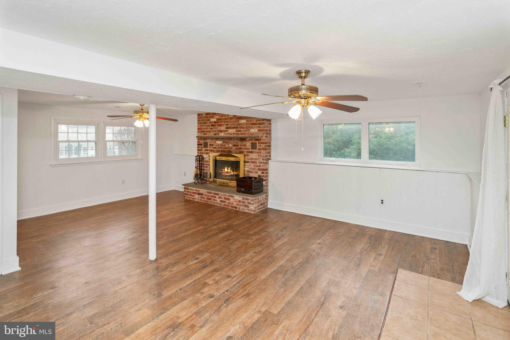 472 Woodward Drive Huntingdon Valley, PA 19006 - Photo 18 of 27 an empty room with wooden floor chandelier fan and windows