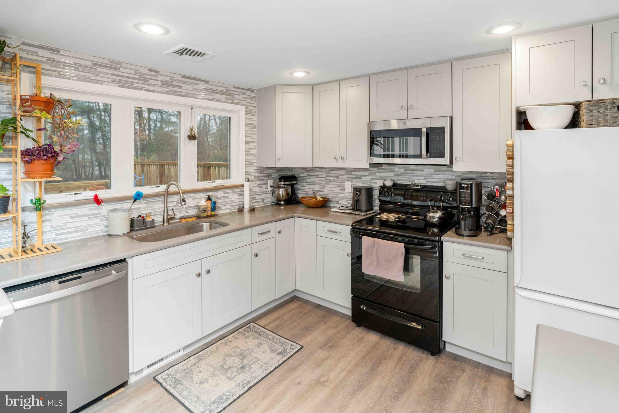 472 Woodward Drive Huntingdon Valley, PA 19006 - Photo 6 of 27 a kitchen with granite countertop white cabinets and white appliances