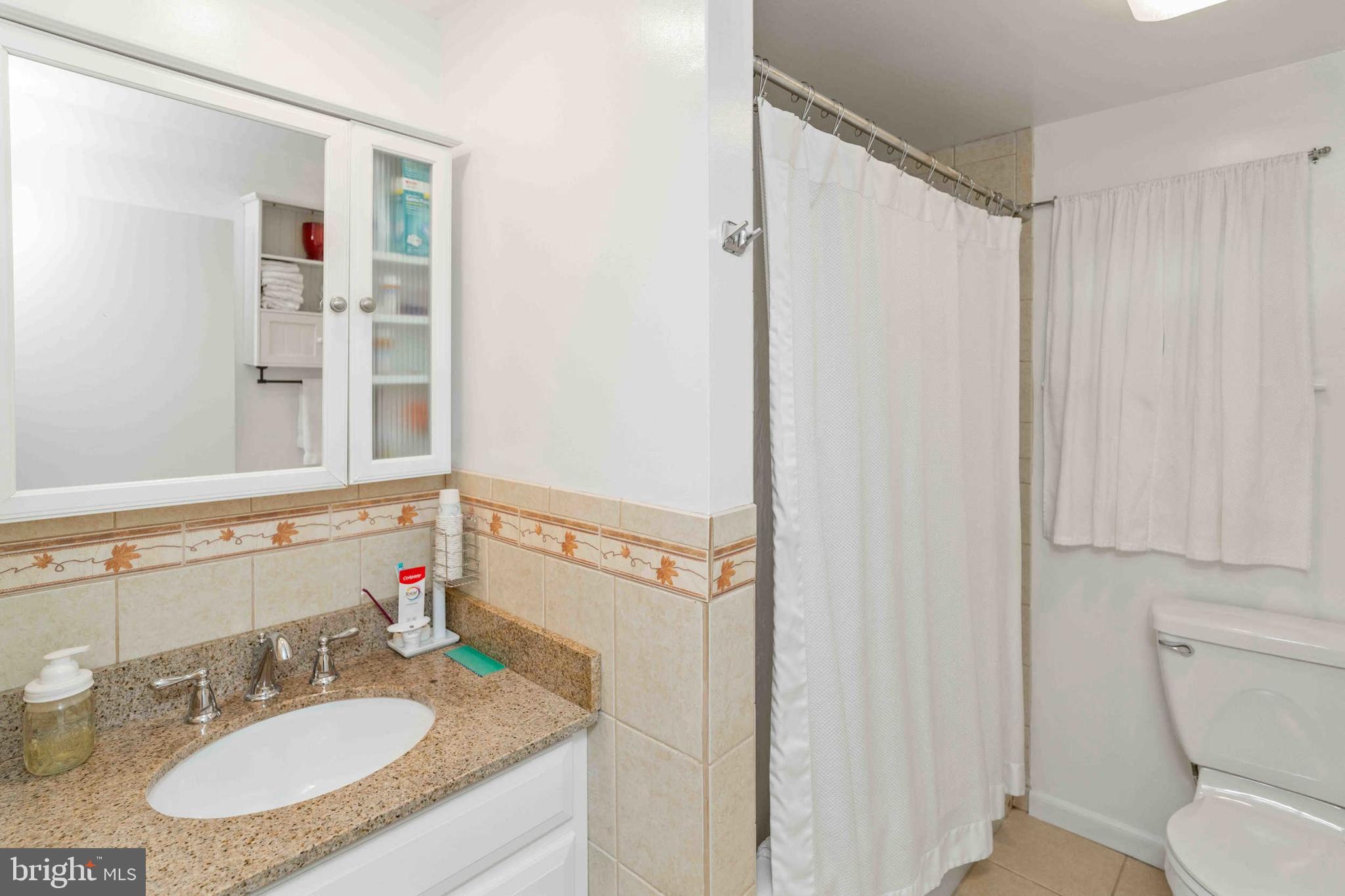 472 Woodward Drive Huntingdon Valley, PA 19006 - Photo 9 of 27 a bathroom with a granite countertop sink and a mirror
