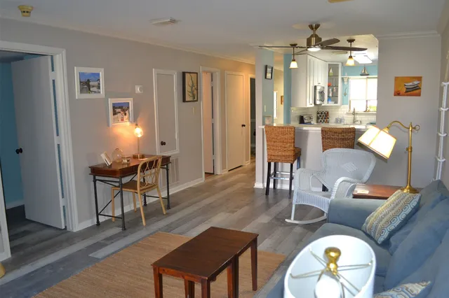 a kitchen with stainless steel appliances a refrigerator sink and white cabinets