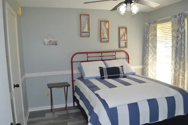 a view of a swimming pool with a lawn chairs under an umbrella