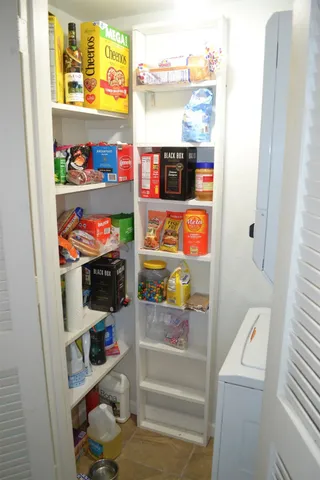 a view of a dining room with furniture and a window