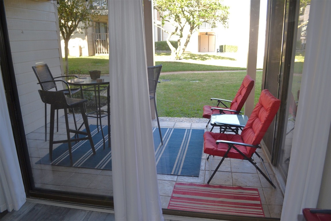 102 Lakeview Terrace, Unit D Conroe, TX 77356 - Photo 21 of 42 a view of a dining room with furniture and a window