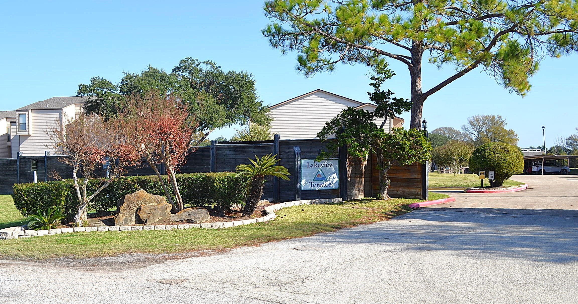 102 Lakeview Terrace, Unit D Conroe, TX 77356 - Photo 37 of 44 a front view of a house with a yard garage and outdoor seating