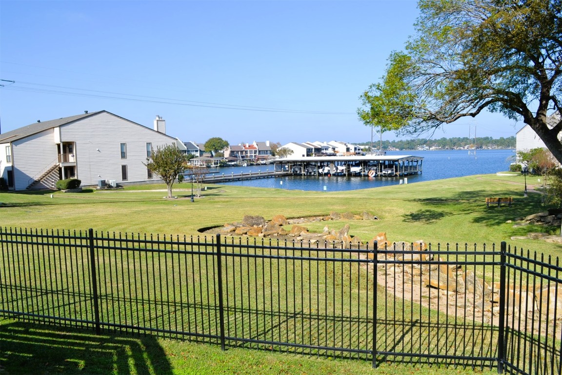 102 Lakeview Terrace, Unit D Conroe, TX 77356 - Photo 38 of 42 a view of a swimming pool with an ocean view